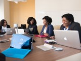 black women in work meeting laughing
