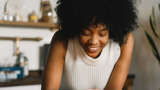 black woman holding lit candle