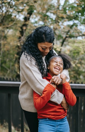 mother and daughter hugging and laughing