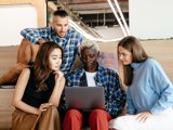 group of people learning from laptop