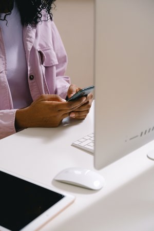 woman on phone by computer