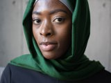 black muslim woman with grey and green headscarf