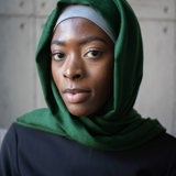 black muslim woman with grey and green headscarf