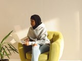 muslim woman sitting on chair working