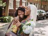 two women hugging and laughing
